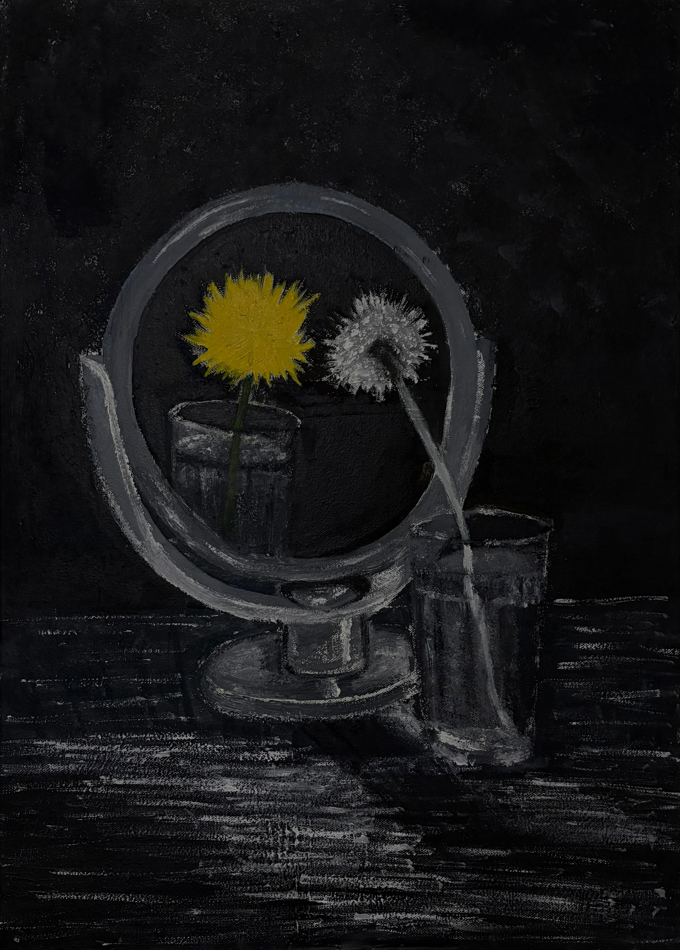 An oval tabletop mirror reflecting yellow and pale flowers, with a glass beside it.